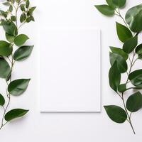a white paper surrounded by green leaves on a white background photo