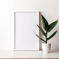 a white frame with a green plant photo