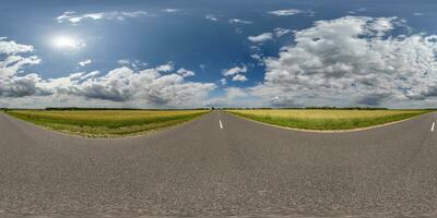 spherical 360 hdri panorama on old asphalt road with clouds and sun on blue sky in equirectangular seamless projection, as skydome replacement in drone panoramas, game development photo