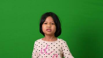 Portrait of Asian angry and sad little girl on green screen background, The emotion of a child when tantrum and mad, expression grumpy emotion. Kid emotional control concept video