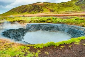 Krysuvik, Seltun, Iceland. Panoramic over geothermal area Krysuvik, Seltun and big boiling cavity filled with hot mud photo