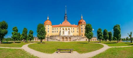 Moritzburg, Saxony, Germany - JPanoramic over famous ancient Moritzburg Castle, near Dresden at sunny summer day with blue sky photo