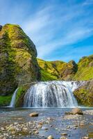 Wonderful waterfall Stjornarfoss at blue sky and sunny day in South Iceland photo