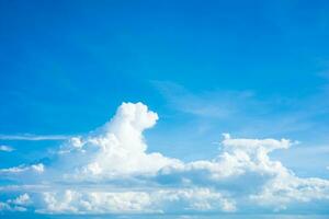 Dark blue sky with white clouds background blue cloud texture Dark blue sky wallpaper with full white clouds and sunlight. photo