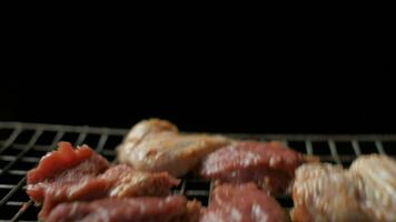 Meat grilling. Chicken thighs on grill grate. Slow motion video
