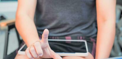woman pointing finger and working with tablet Suitable for making infographics. photo