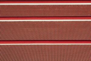 Slope angle view of red temple tile roof in different level photo