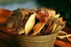 Fresh seafood in zinc tank such as crab, octopus, and shell for preparing the grilling in the restaurant photo