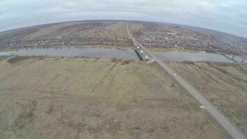 Aerial shot of cars driving on bridge over the river video