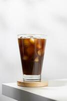 Iced americano in a glass on a white table. photo