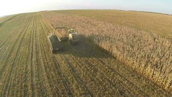 Harvesting crops on vast farmlands, aerial view video