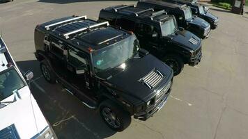 Hummer vehicles on parking lot, aerial view video