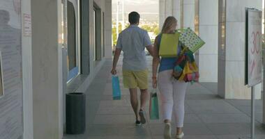 Young people leaving trade centre being happy with shopping video