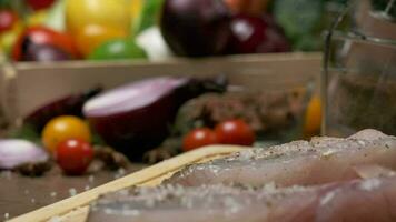 Professional chef prepares white fish steak for frying. Close up slow motion. video