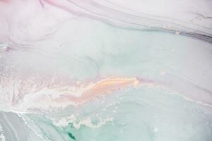 Painting created with alcohol ink. Soft smooth color transitions combined with clear gold and silver edges. Blue, pink, green abstract color combination. photo