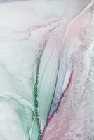 Painting created with alcohol ink. Soft smooth color transitions combined with clear gold and silver edges. Blue, pink, green abstract color combination. photo