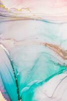 Painting created with alcohol ink. Soft smooth color transitions combined with clear gold and silver edges. Blue, pink, green abstract color combination. photo