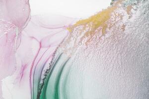 Painting created with alcohol ink. Soft smooth color transitions combined with clear gold and silver edges. Blue, pink, green abstract color combination. photo