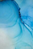 Painting created with alcohol ink. Soft smooth color transitions combined with clear gold and silver edges. Blue, pink, green abstract color combination. photo