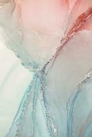 Painting created with alcohol ink. Soft smooth color transitions combined with clear gold and silver edges. Blue, pink, green abstract color combination. photo