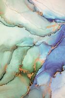 Painting created with alcohol ink. Soft smooth color transitions combined with clear gold and silver edges. Blue, pink, green abstract color combination. photo