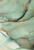 Painting created with alcohol ink. Soft smooth color transitions combined with clear gold and silver edges. Blue, pink, green abstract color combination. photo