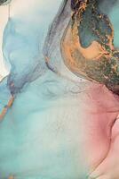 Painting created with alcohol ink. Soft smooth color transitions combined with clear gold and silver edges. Blue, pink, green abstract color combination. photo