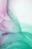 Painting created with alcohol ink. Soft smooth color transitions combined with clear gold and silver edges. Blue, pink, green abstract color combination. photo