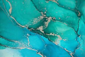 Painting created with alcohol ink. Soft smooth color transitions combined with clear gold and silver edges. Blue, pink, green abstract color combination. photo