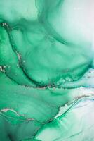 Painting created with alcohol ink. Soft smooth color transitions combined with clear gold and silver edges. Blue, pink, green abstract color combination. photo