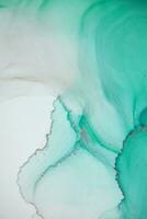 Painting created with alcohol ink. Soft smooth color transitions combined with clear gold and silver edges. Blue, pink, green abstract color combination. photo
