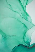 Painting created with alcohol ink. Soft smooth color transitions combined with clear gold and silver edges. Blue, pink, green abstract color combination. photo