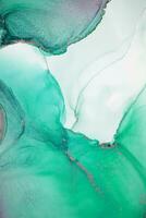 Painting created with alcohol ink. Soft smooth color transitions combined with clear gold and silver edges. Blue, pink, green abstract color combination. photo