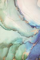 Painting created with alcohol ink. Soft smooth color transitions combined with clear gold and silver edges. Blue, pink, green abstract color combination. photo