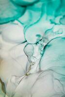 Alcohol ink sea texture. Artistic bright splash. Liquid artwork. Abstract ethereal swirl. Fragment of artwork. Trendy modern art. Inspired by the sky, as well as steam and smoke. photo