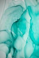 Alcohol ink sea texture. Artistic bright splash. Liquid artwork. Abstract ethereal swirl. Fragment of artwork. Trendy modern art. Inspired by the sky, as well as steam and smoke. photo