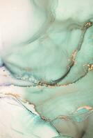 Painting created with alcohol ink. Soft smooth color transitions combined with clear gold and silver edges. Blue, pink, green abstract color combination. photo