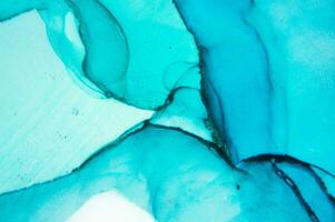 The picture is painted in alcohol ink. Abstraction will perfectly fit into a modern interior. Closeup of the painting. Colorful abstract painting background. photo