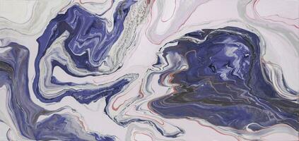 Abstract created using the technique of liquid acrylic. Macro photography of the smallest details of a picture. The picture shows how overflows of shades and colors of paint resemble space motifs. photo