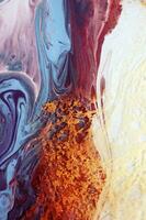 Abstract created using the technique of liquid acrylic. Macro photography of the smallest details of a panting. The panting shows how overflows of shades and colors of paint resemble space motifs. photo