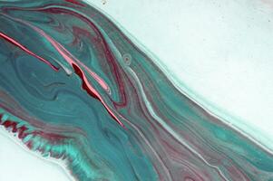 Abstract created using the technique of liquid acrylic. Macro photography of the smallest details of a panting. The panting shows how overflows of shades and colors of paint resemble space motifs. photo
