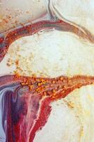 Abstract created using the technique of liquid acrylic. Macro photography of the smallest details of a panting. The panting shows how overflows of shades and colors of paint resemble space motifs. photo