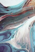 Abstract created using the technique of liquid acrylic. Macro photography of the smallest details of a panting. The panting shows how overflows of shades and colors of paint resemble space motifs. photo