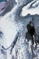 Abstract created using the technique of liquid acrylic. Macro photography of the smallest details of a picture. The picture shows how overflows of shades and colors of paint resemble space motifs. photo