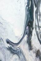 Abstract created using the technique of liquid acrylic. Macro photography of the smallest details of a picture. The picture shows how overflows of shades and colors of paint resemble space motifs. photo