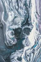 Abstract created using the technique of liquid acrylic. Macro photography of the smallest details of a picture. The picture shows how overflows of shades and colors of paint resemble space motifs. photo