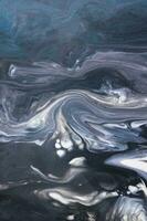 Abstract created using the technique of liquid acrylic. Macro photography of the smallest details of a picture. The picture shows how overflows of shades and colors of paint resemble space motifs. photo