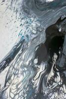 Abstract created using the technique of liquid acrylic. Macro photography of the smallest details of a picture. The picture shows how overflows of shades and colors of paint resemble space motifs. photo