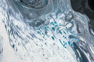 Abstract created using the technique of liquid acrylic. Macro photography of the smallest details of a picture. The picture shows how overflows of shades and colors of paint resemble space motifs. photo