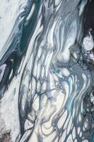 Abstract created using the technique of liquid acrylic. Macro photography of the smallest details of a picture. The picture shows how overflows of shades and colors of paint resemble space motifs. photo